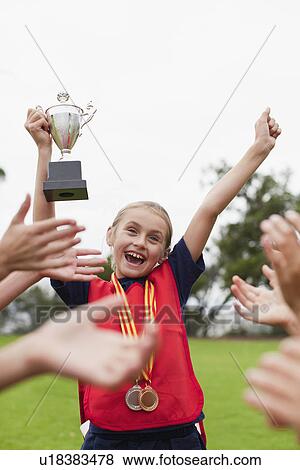 Children cheering teammate with trophy View Large Photo Image Stock Photo - Children cheering teammate with trophy. Fotosearch