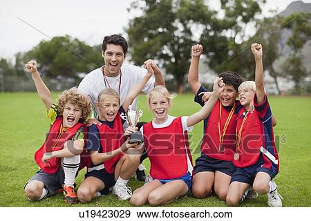 Stock Photo - Children cheering with coach. Fotosearch
