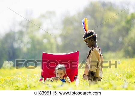 Stock Photography - Children playing dress up outdoors. Fotosearch