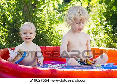 Children playing in inflatable pool View Large Photo Image Picture - Children playing in inflatable pool. Fotosearch