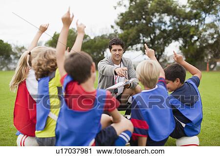 Stock Image - Children raising hands during practice. Fotosearch