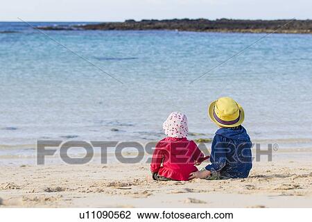 Children sitting on sandy beach View Large Photo Image Stock Image - Children sitting on sandy beach. Fotosearch