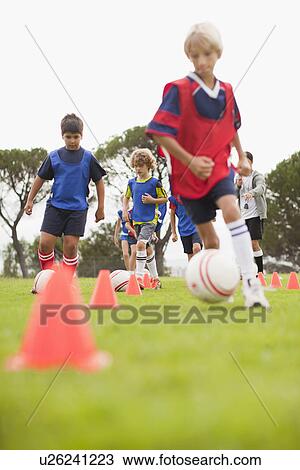 Childrens soccer team training on pitch View Large Photo Image Stock Image - Childrens soccer team training on pitch. Fotosearch