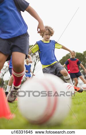 Childrens soccer team training on pitch View Large Photo Image Stock Photography - Childrens soccer team training on pitch. Fotosearch