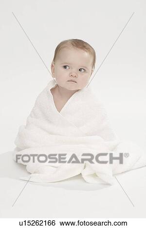 Stock Photograph - Close up of baby girl wearing bathrobe. Fotosearch