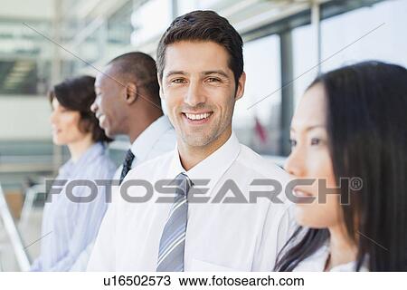 Stock Image - Close up of businessmans smiling face. Fotosearch