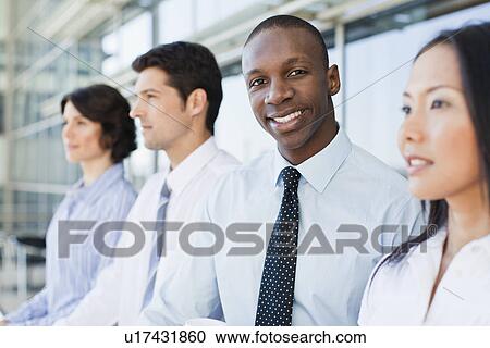 Stock Image - Close up of businessmans smiling face. Fotosearch