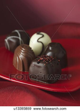 Stock Photo - Close up of chocolates on plate. Fotosearch