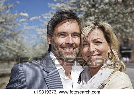 Stock Image - Close up of couples smiling face. Fotosearch