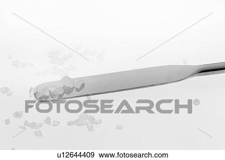 Stock Photo - Close up of crystals on metal spatula. Fotosearch