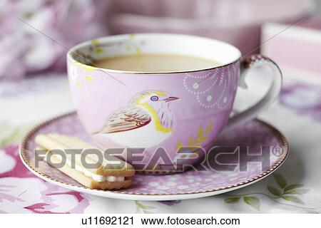 Close up of cup of tea and cookie View Large Photo Image Stock Image - Close up of cup of tea and cookie. Fotosearch