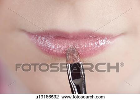 Close up of girl applying makeup View Large Photo Image Stock Image - Close up of girl applying makeup. Fotosearch