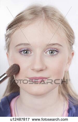 Stock Photo - Close up of girl applying makeup. Fotosearch