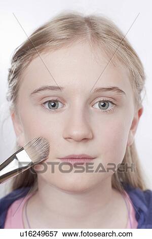 Close up of girl applying makeup View Large Photo Image Stock Photo - Close up of girl applying makeup. Fotosearch