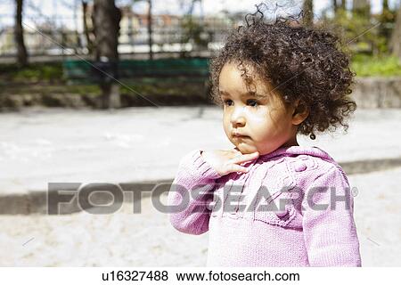Close up of girl standing in park View Large Photo Image Stock Photo - Close up of girl standing in park. Fotosearch