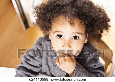 Close up of girl with fingers in mouth View Large Photo Image Stock Photo - Close up of girl with fingers in mouth. Fotosearch