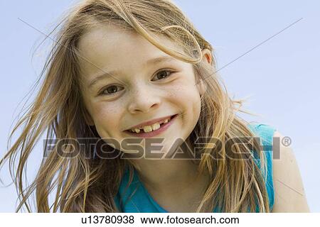 Close up of girls smiling face View Large Photo Image Stock Photo - Close up of girls smiling face. Fotosearch