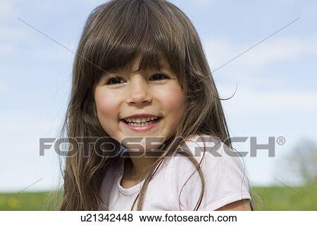 Stock Photo - Close up of girls smiling face. Fotosearch