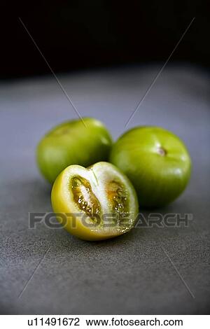 Stock Image - Close up of halved tomatillo. Fotosearch