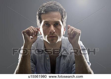 Close up of man standing indoors View Large Photo Image Stock Image - Close up of man standing indoors. Fotosearch