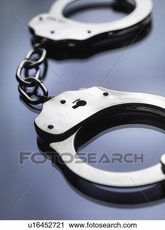 Close up of metal handcuffs View Large Photo Image Stock Image - Close up of metal handcuffs. Fotosearch