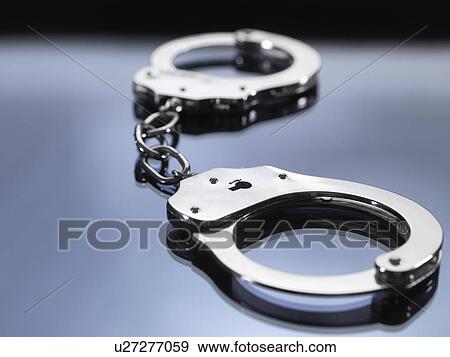Close up of metal handcuffs View Large Photo Image Stock Photo - Close up of metal handcuffs. Fotosearch