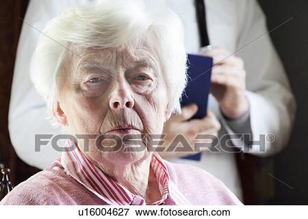 Close up of older womans frowning face View Large Photo Image Stock Photo - Close up of older womans frowning face. Fotosearch