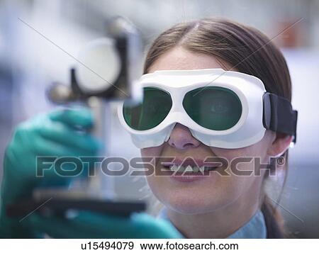 Stock Photo - Close up of scientist wearing goggles. Fotosearch