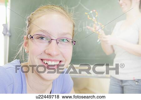 Close up of student smiling in class View Large Photo Image Stock Photo - Close up of student smiling in class. Fotosearch