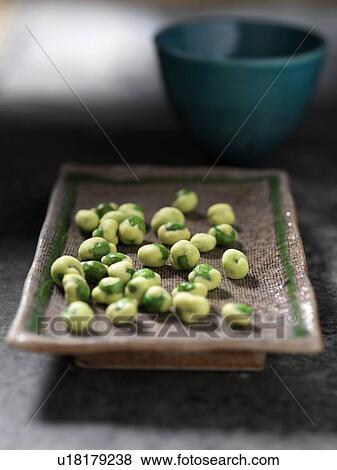 Stock Photo - Close up of tray of wasabi peas. Fotosearch