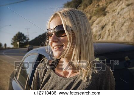 Close up of woman wearing sunglasses View Large Photo Image Stock Photograph - Close up of woman wearing sunglasses. Fotosearch