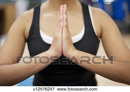 Stock Photo - Close up of womans clasped hands. Fotosearch
