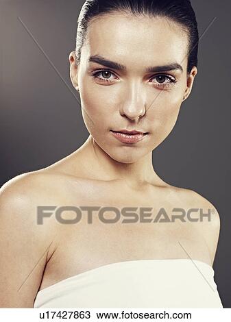Stock Image - Close up of womans face and shoulders. Fotosearch