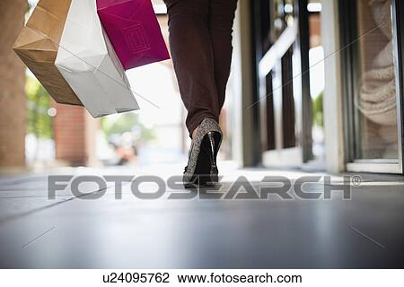 Stock Image - Close up of womans shoe on city street. Fotosearch