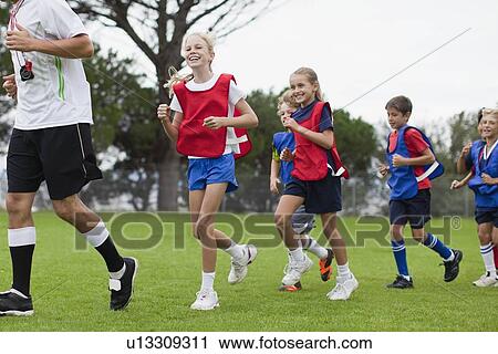 Coach training children on field View Large Photo Image Stock Image - Coach training children on field. Fotosearch