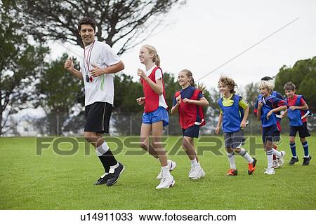 Coach training children on field View Large Photo Image Stock Image - Coach training children on field. Fotosearch