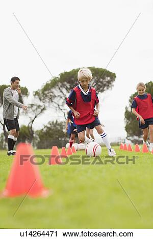 Coach training childrens soccer team View Large Photo Image Stock Image - Coach training childrens soccer team. Fotosearch