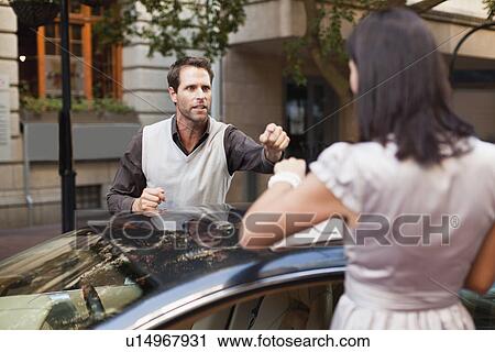 Couple arguing over sports car View Large Photo Image Stock Image - Couple arguing over sports car. Fotosearch