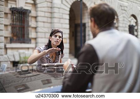 Couple arguing over sports car View Large Photo Image Stock Image - Couple arguing over sports car. Fotosearch