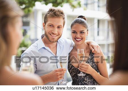Couple drinking champagne together View Large Photo Image Stock Photograph - Couple drinking champagne together. Fotosearch