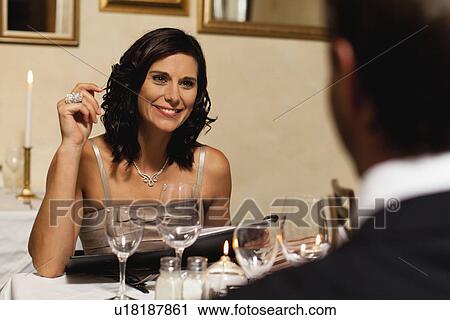 Couple having dinner in restaurant View Large Photo Image Stock Image - Couple having dinner in restaurant. Fotosearch