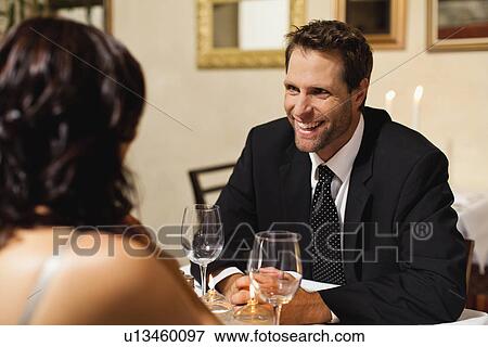 Couple having dinner in restaurant View Large Photo Image Stock Photo - Couple having dinner in restaurant. Fotosearch