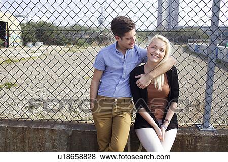 Stock Photo - Couple hugging on city street. Fotosearch