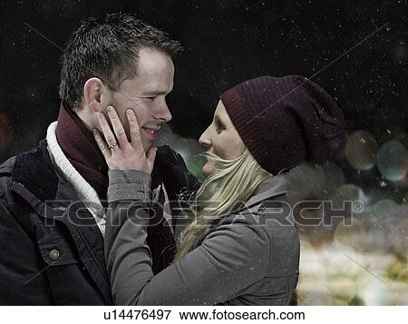 Couple hugging outdoors at night View Large Photo Image Stock Photo - Couple hugging outdoors at night. Fotosearch
