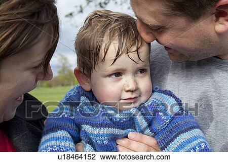 Couple hugging toddler son View Large Photo Image Stock Image - Couple hugging toddler son. Fotosearch