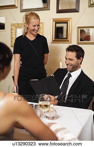 Couple ordering dinner in restaurant View Large Photo Image Stock Image - Couple ordering dinner in restaurant. Fotosearch