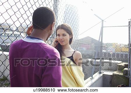 Couple talking on city street View Large Photo Image Stock Image - Couple talking on city street. Fotosearch
