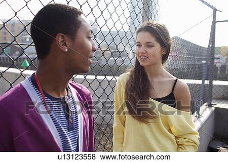 Couple talking on city street View Large Photo Image Stock Photo - Couple talking on city street. Fotosearch