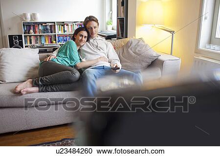 Couple watching television together View Large Photo Image Stock Image - Couple watching television together. Fotosearch