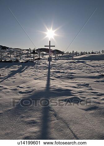 Stock Image - Crosses in graveyard casting shadows. Fotosearch